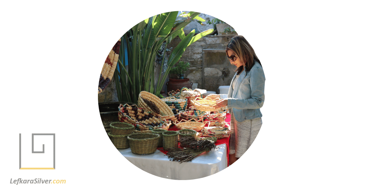 a woman meticulously inspecting traditional Cypriot artifact