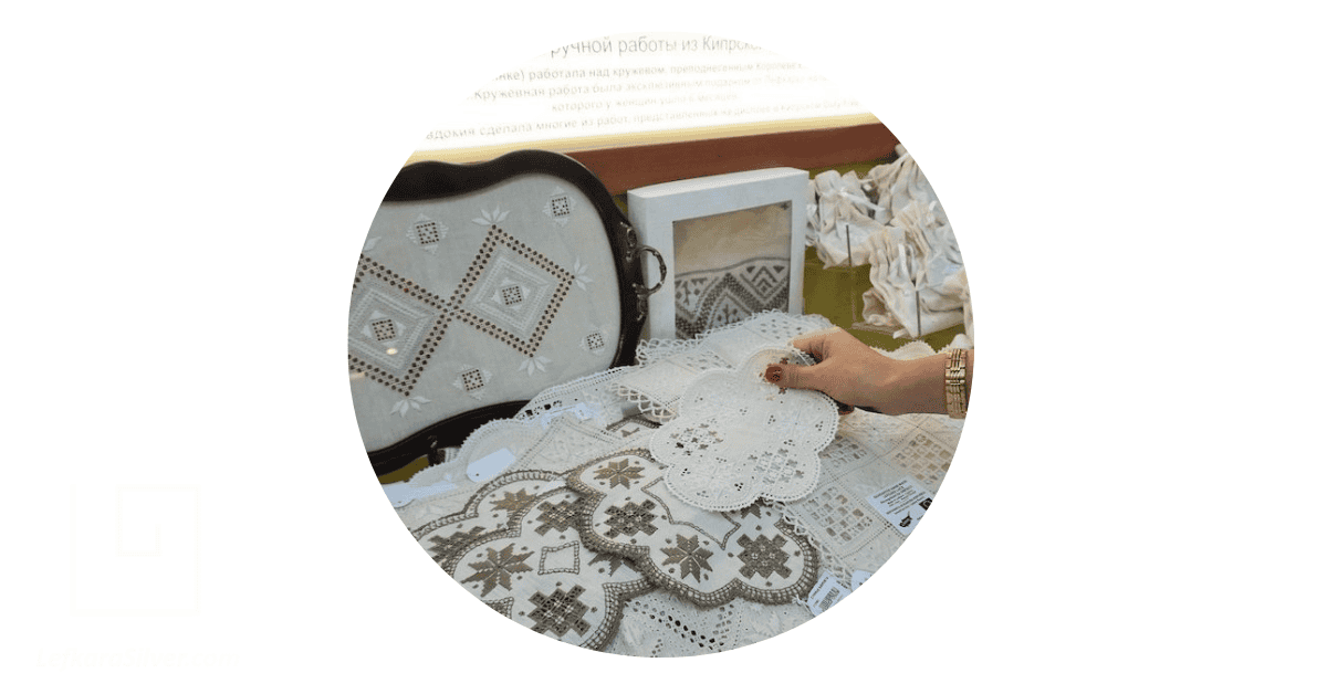 a woman perusing through samples of Cyprus lace