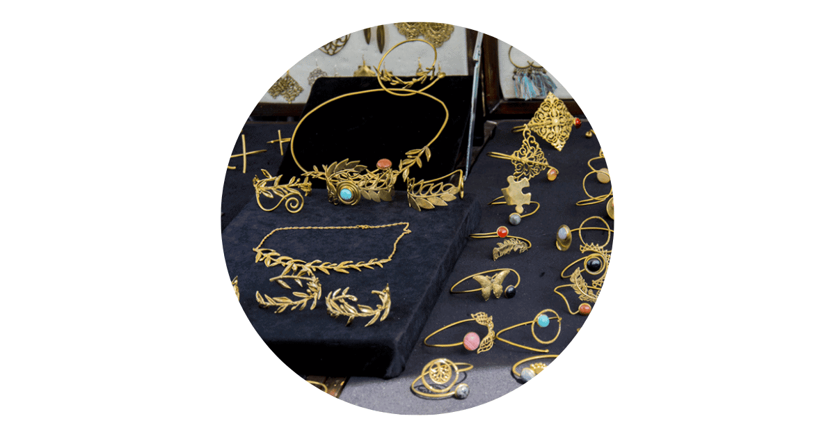 gold greece jewellery on display in a store