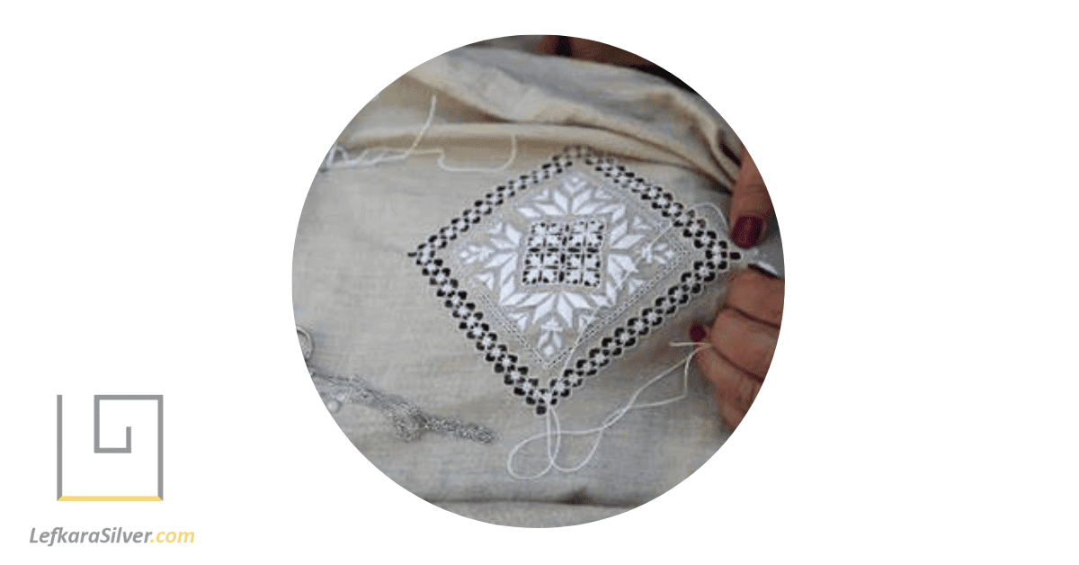 a person participating in a traditional Lefkara lace making process.