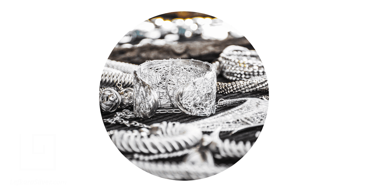 a collection of silver bracelets and necklaces
