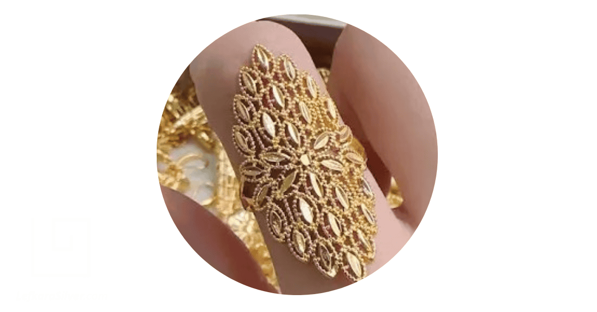 a person wearing a gold filigree ring