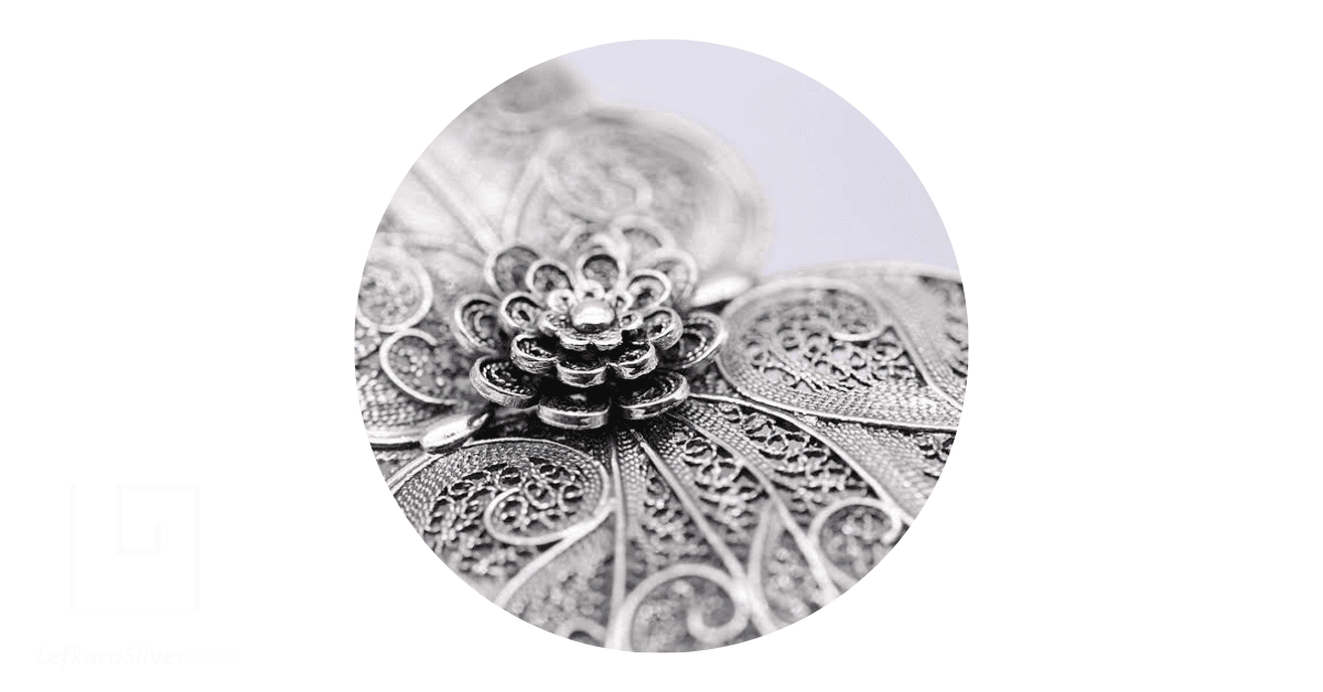Close up of a delicate silver filigree earring