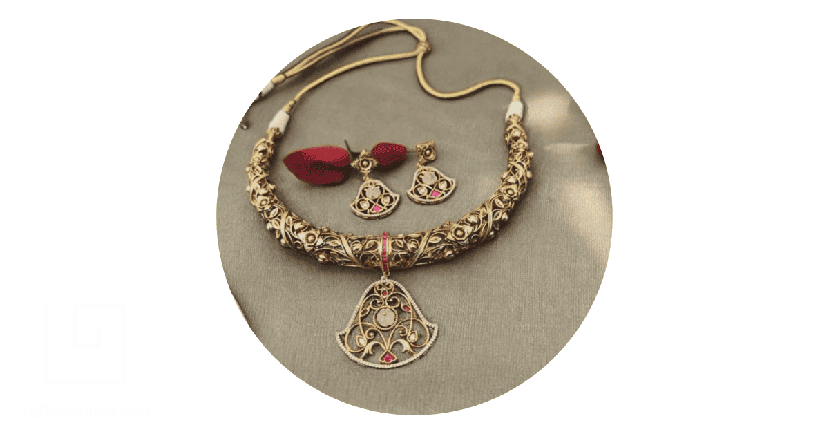 an antique filigree jewelry set laid out on a jewelry polish cloth