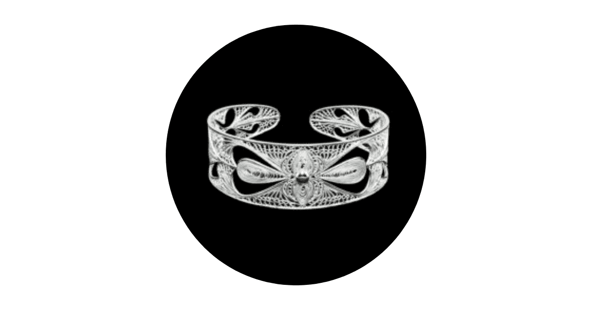 a custom made silver filigree bangle on a black background