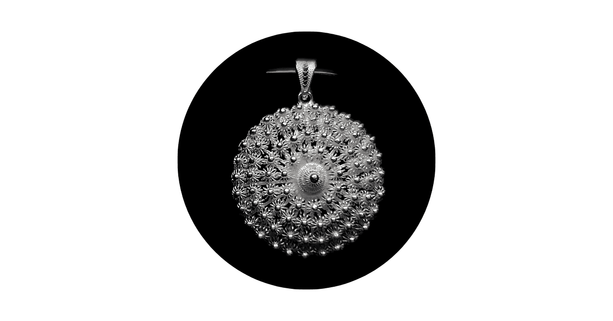 A silver filigree pendant.