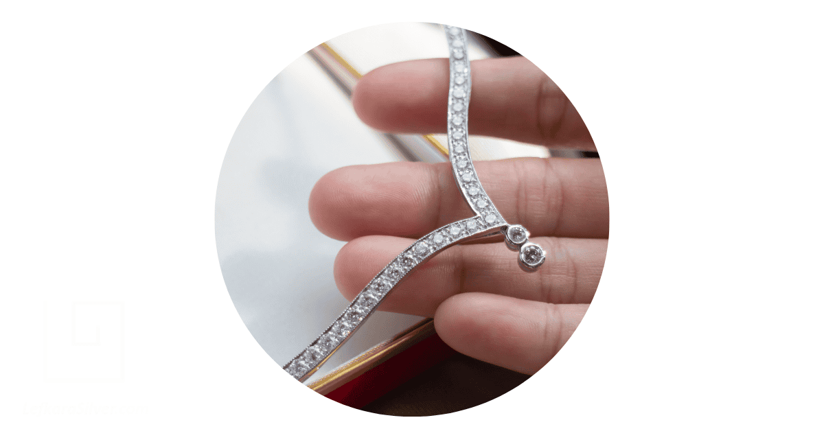 a person holding a fine silver jewelry necklace