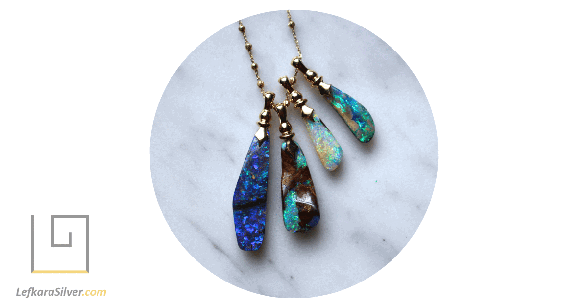 a stunning boulder opals necklace, the opal's vibrant colors contrasting beautifully against the light background.