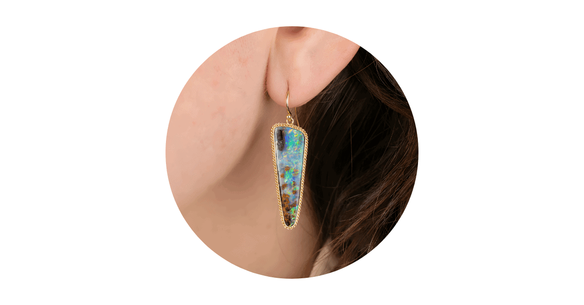 A woman's ear adorned with a Boulder opal earring.