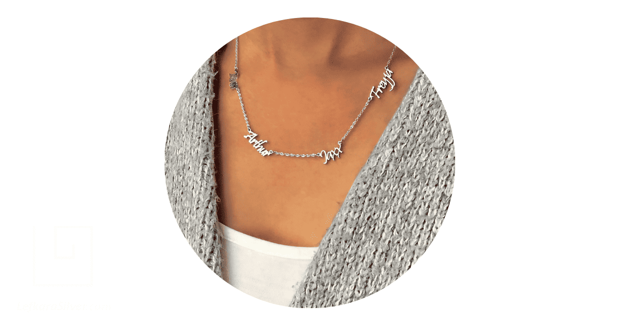 a woman wearing a custom silver jewelry necklace with multiple name pendants
