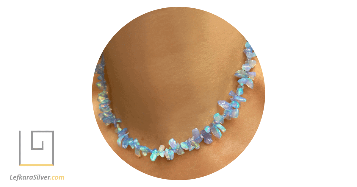 a woman wearing a rough cut ethiopian opal necklace.