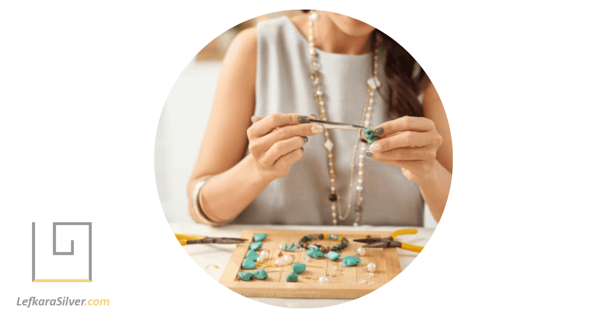 a woman delicately making handmade beaded jewelry