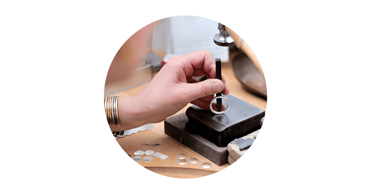 A Silversmith making silver rings. 