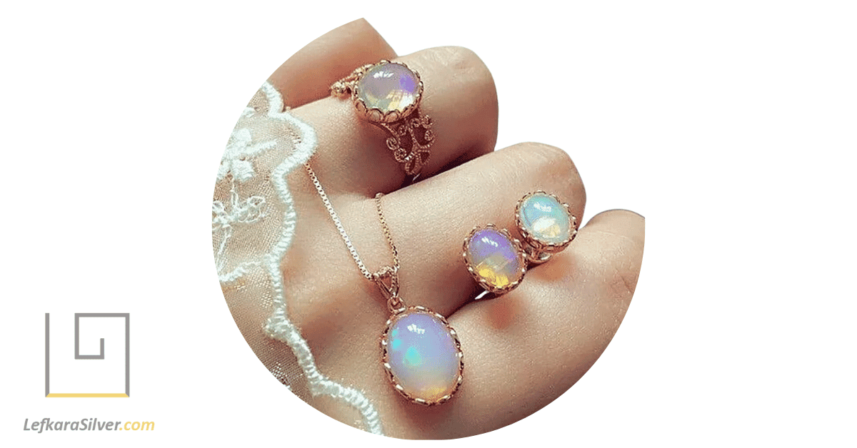 a woman holding stunning opal jewelry, the opal's iridescent colors shimmering in the light.