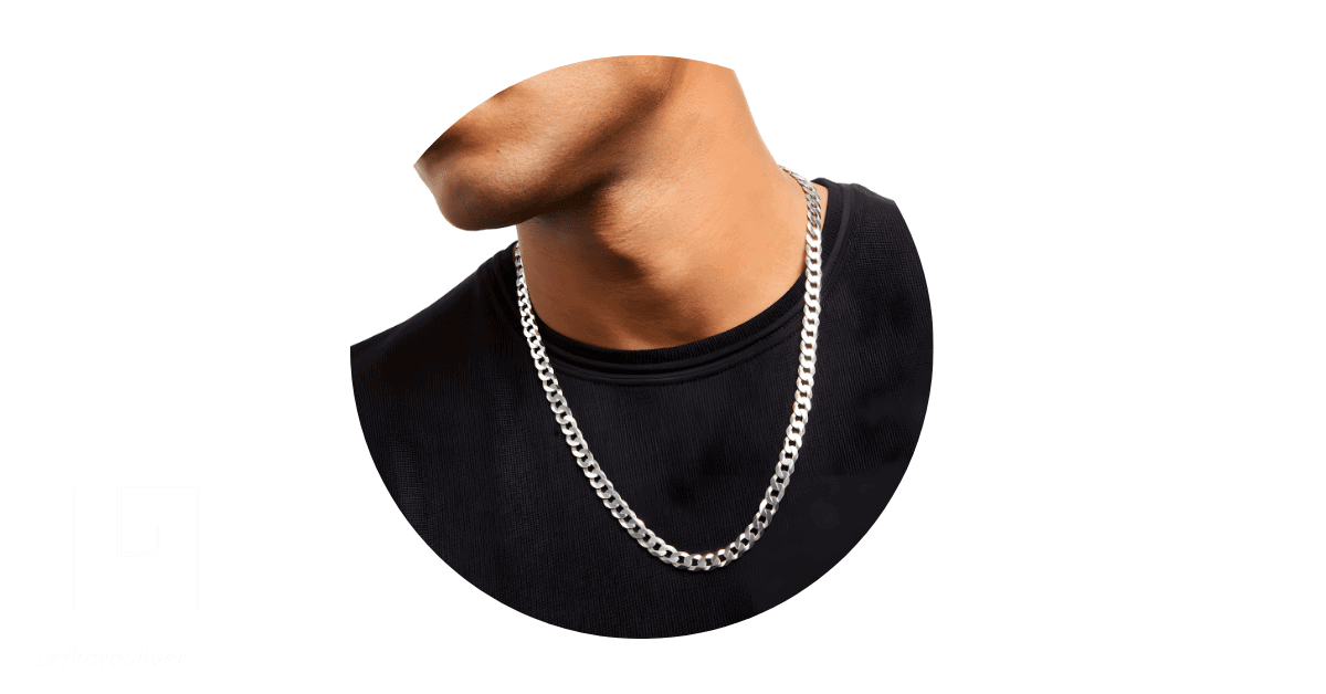 a man's neck adorned with a curb silver chain.