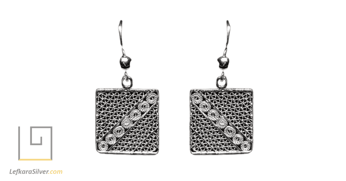 a pair of silver filigree earrings