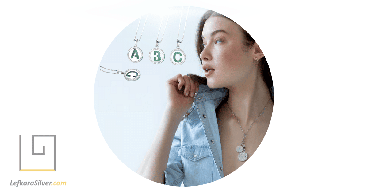 a woman admiring a silver pendants