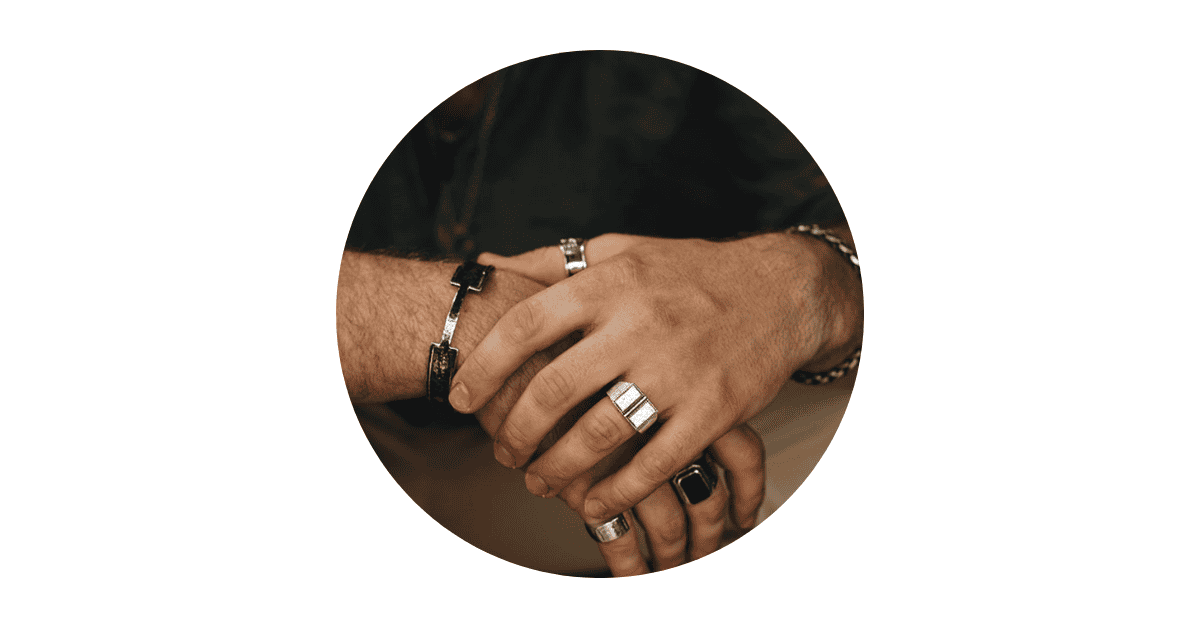 Stylish men's silver rings on hands.