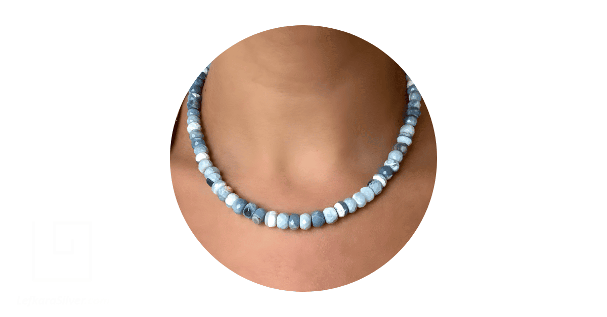 A woman's neck adorned with a blue Australian opal beads necklace.