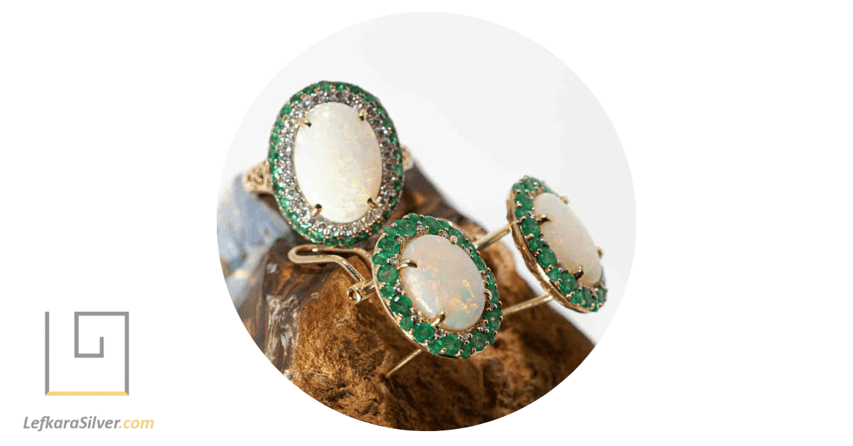 a display of emerald and opal jewelry