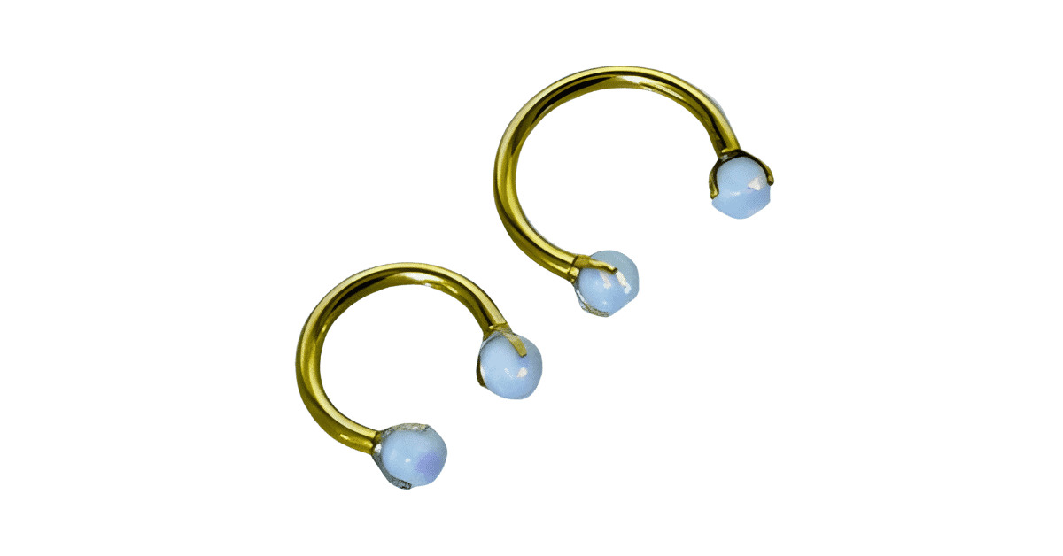 A pair of opal daith septum piercing jewelry.