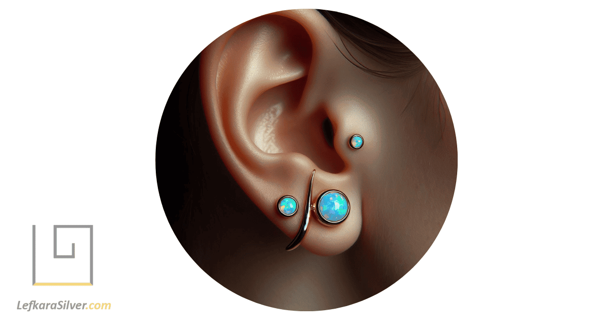 a person wearing an opal tragus jewelry piece, with a close-up on the ear.
