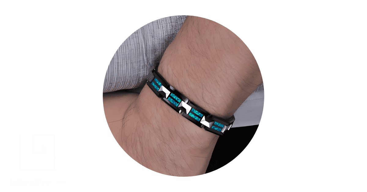 Aman's wrist adorned with men's opal jewelry.