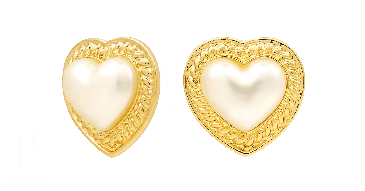 a pair of gold heart-shaped pearl earrings. 