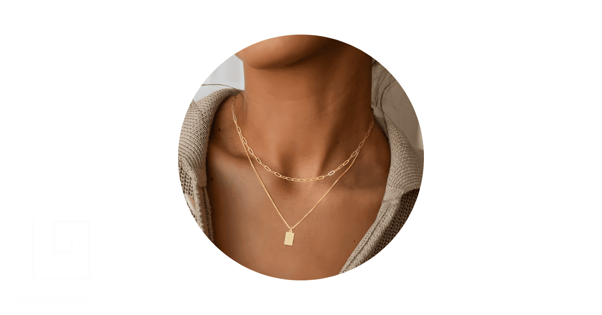 A beautiful layered necklace on a woman's neck. 