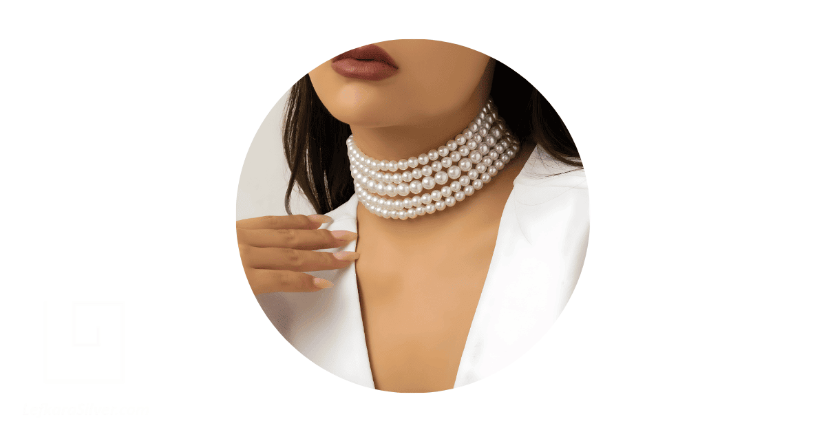 a person neck adorned with layered pearl necklace.