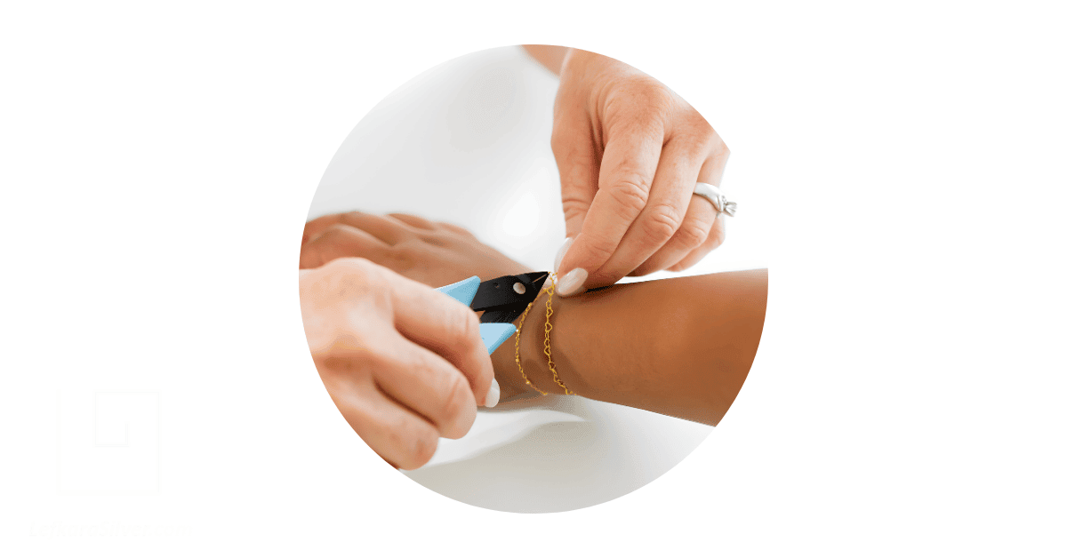a jeweller zapping a permanent bracelet on a client's wrist.
