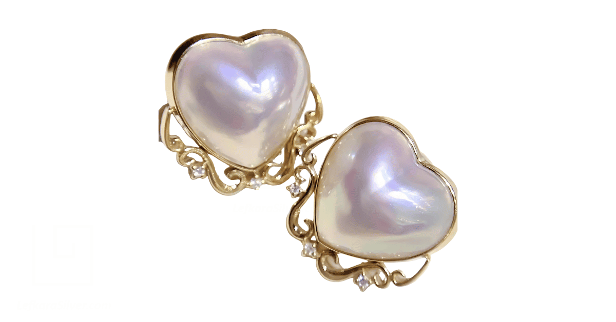 A pair of heart-shaped pearl earrings. 