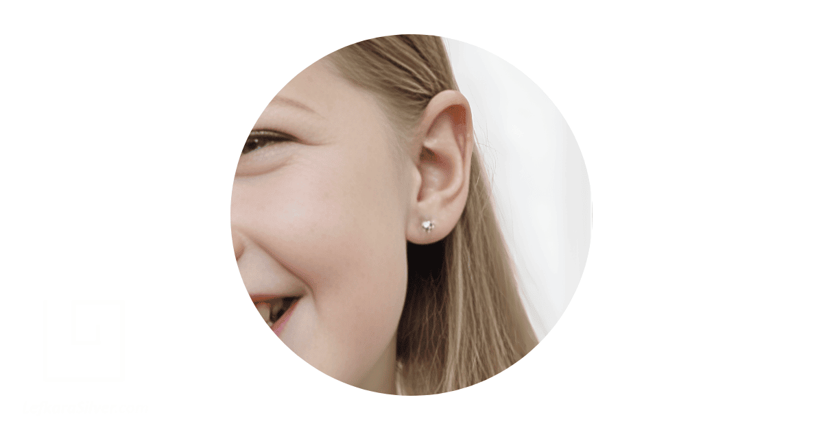 A child's ear adorned with a sterling silver earring for kids