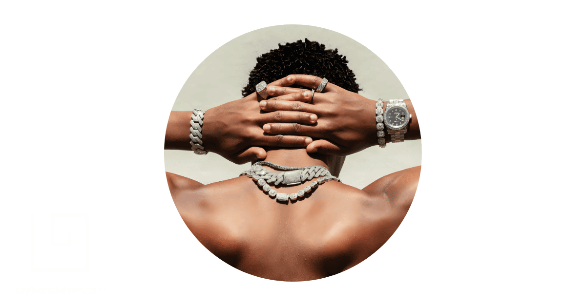 a man adorned with jewelry on his neck, wrists, and fingers.