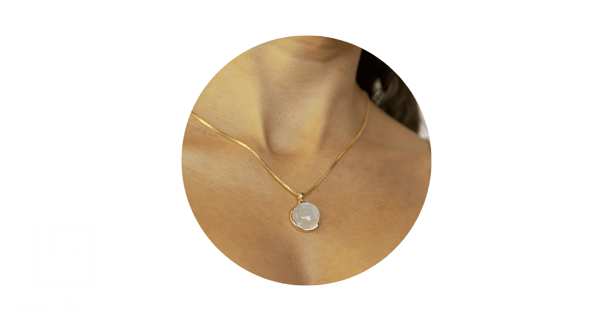 a moonstone necklace on a person's neck.
