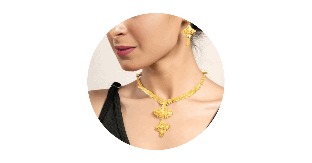 a woman's neck and ear adorned with gold plated jewelry.