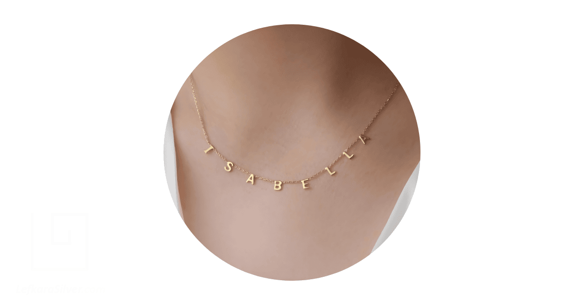 a person's neck adorned with a custom name necklace.