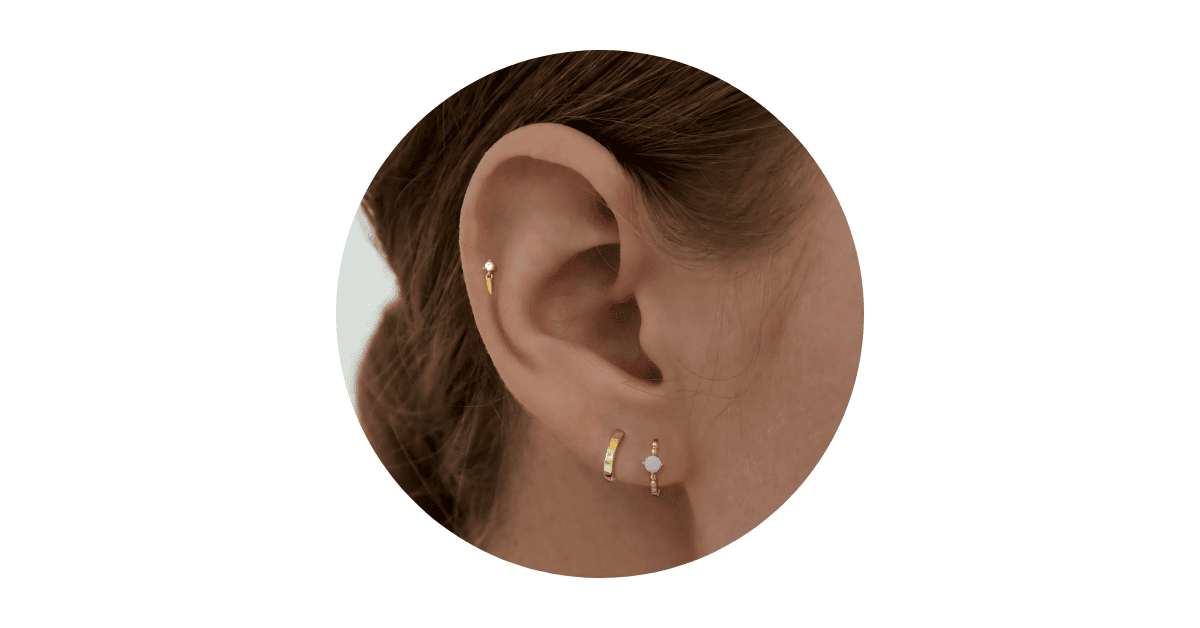 a person's ears adorned with dainty earrings.
