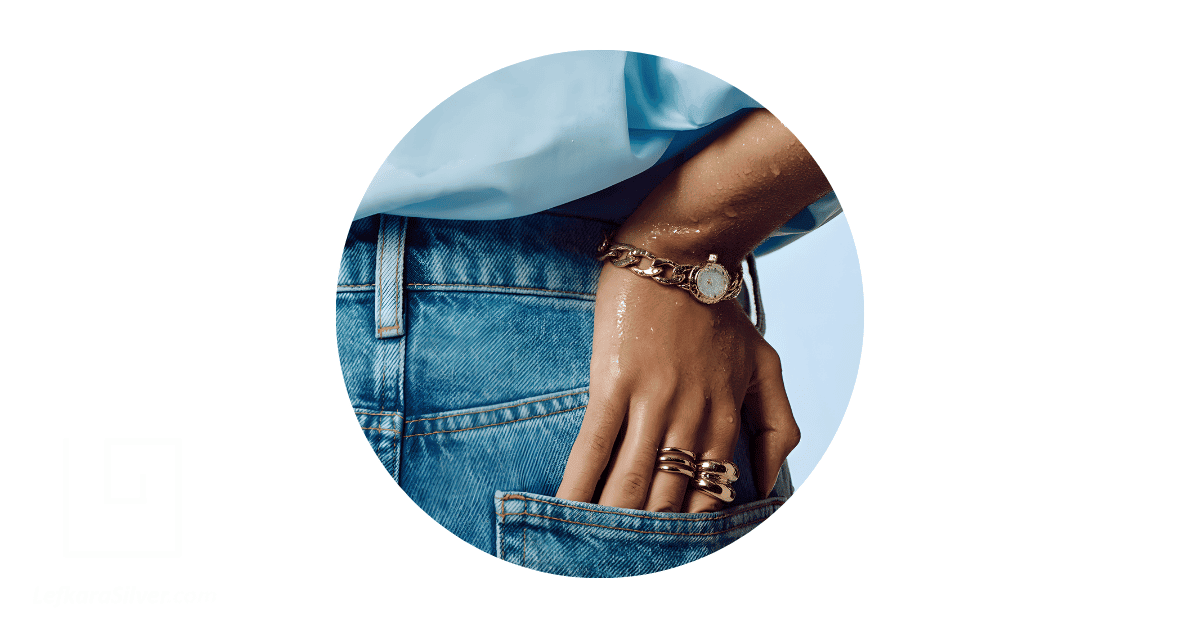 A person's sweating hand adorned with non tarnish jewelry. 