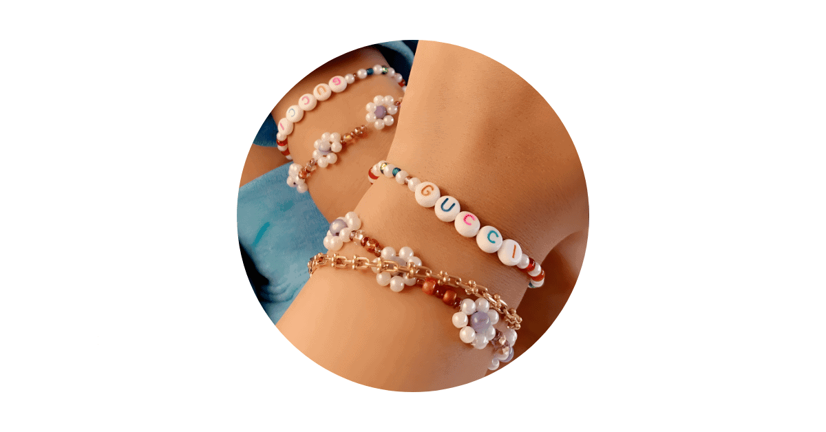 A person's wrist adorned with DIY bracelets.