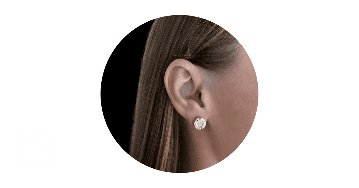 a woman's ear adorned with a simple gold stud earring from Lefkara Silbver.