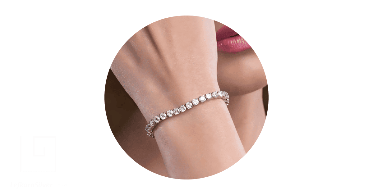 a person's wrist adorned with a tennis bracelet.