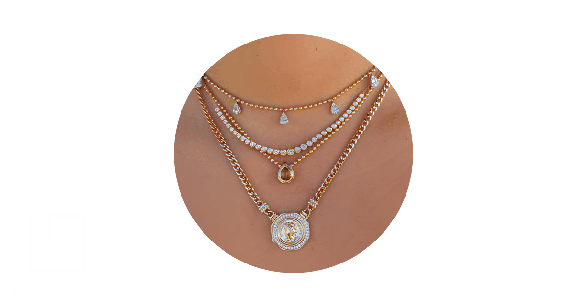 a woman's neck layered with a stack of necklaces. 