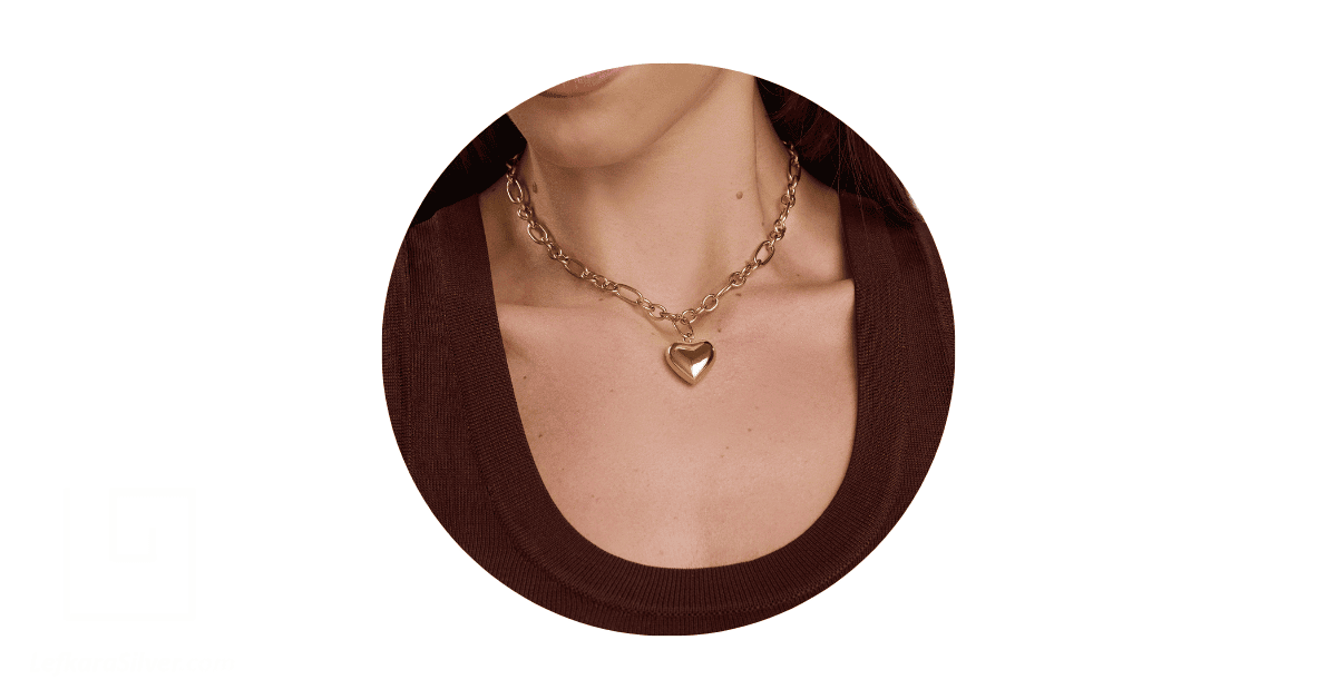 a woman's neck adorned with a gold necklace. 