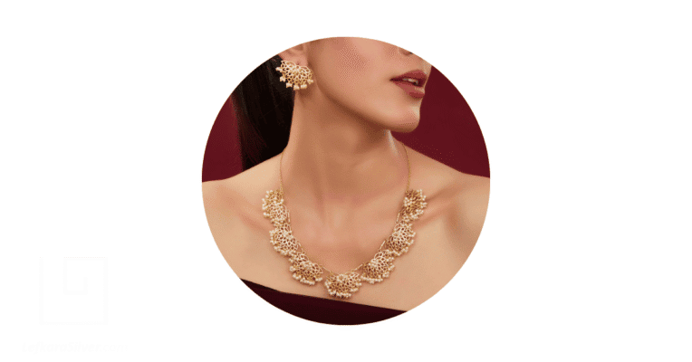 a woman wearing gold filigree earrings and a necklace.