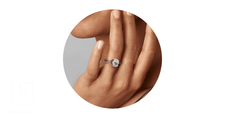 a woman's finger adorned with a white gold ring.