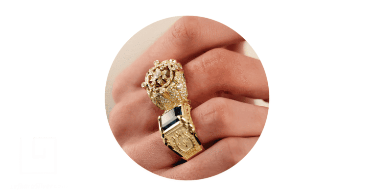 a man's fingers adorned with gold rings.