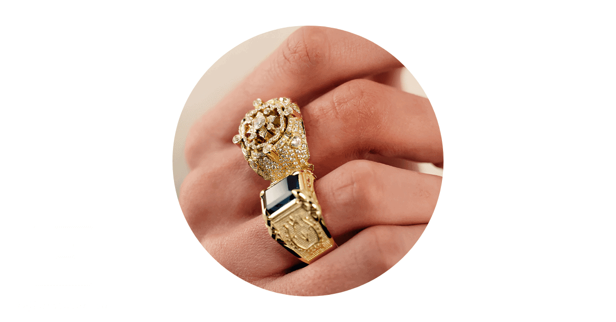 a man's fingers adorned with gold rings.