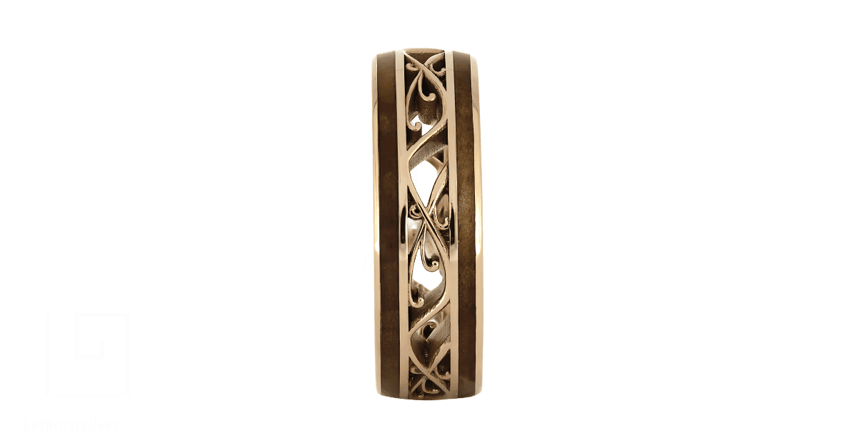 a gold filigree wedding band with wooden aesthetics.
