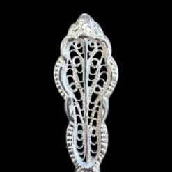 Handmade silver filigree christening teaspoon with an ornate scrolled openwork handle, by Lefkara Silver Cyprus.
